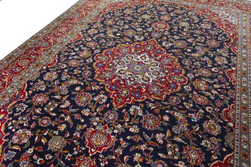 Backside of handmade 2000s Kashan rug showing knot structure and weave density