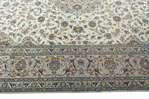 Corner detail of 2000s Kashan rug showing border pattern and Wool pile