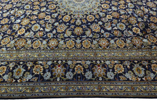 Corner detail of 2000s Kashan rug showing border pattern and Wool pile