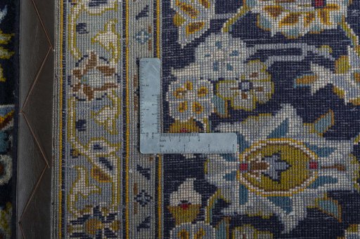 Backside of handmade 2000s Kashan rug showing knot structure and weave density