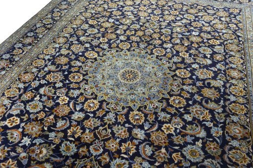 Backside of handmade 2000s Kashan rug showing knot structure and weave density