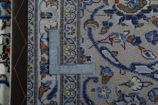 Backside of handmade 2000s Kashan rug showing knot structure and weave density