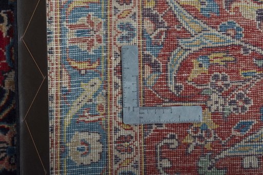Backside of handmade 2000s Kashan rug showing knot structure and weave density