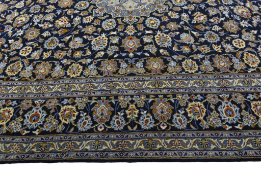 Corner detail of 2000s Kashan rug showing border pattern and Wool pile