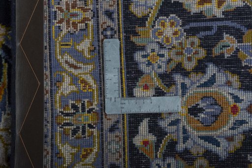 Backside of handmade 2000s Kashan rug showing knot structure and weave density
