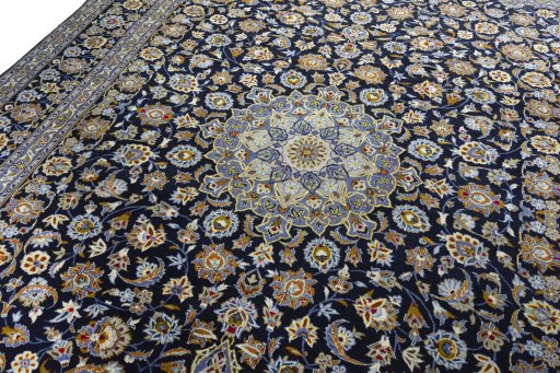 Backside of handmade 2000s Kashan rug showing knot structure and weave density
