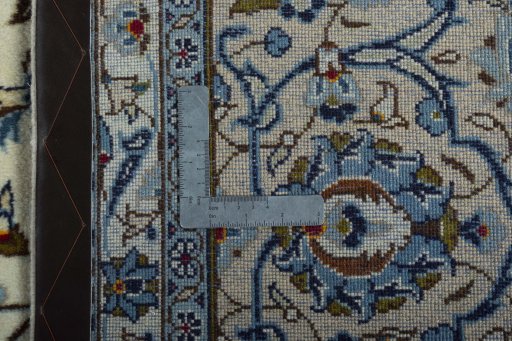 Backside of handmade 2000s Kashan rug showing knot structure and weave density