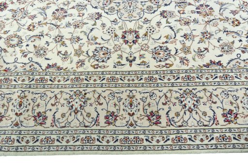 Corner detail of 2000s Kashan rug showing border pattern and Wool pile