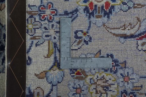 Backside of handmade New Kashan rug showing knot structure and weave density