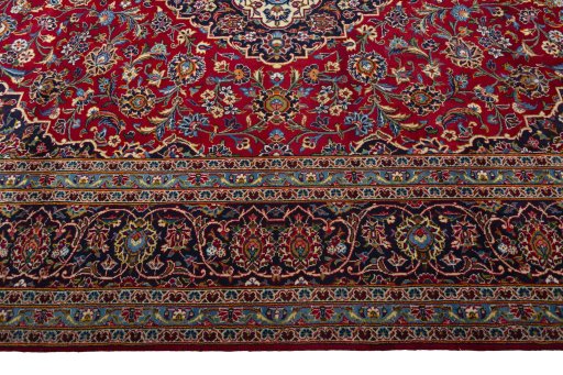 Corner detail of 2000s Kashan rug showing border pattern and Wool pile