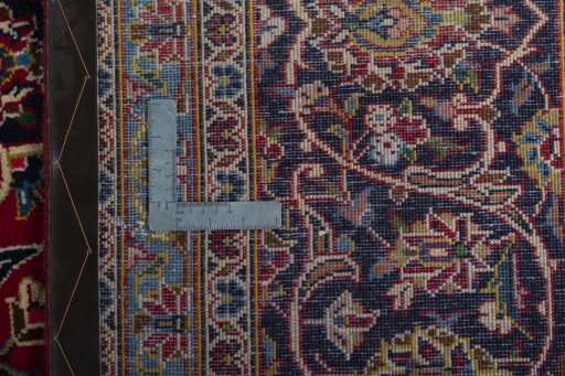 Backside of handmade 2000s Kashan rug showing knot structure and weave density