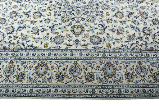 Corner detail of 2000s Kashan rug showing border pattern and Wool pile