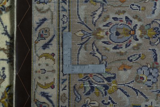 Backside of handmade 2000s Kashan rug showing knot structure and weave density