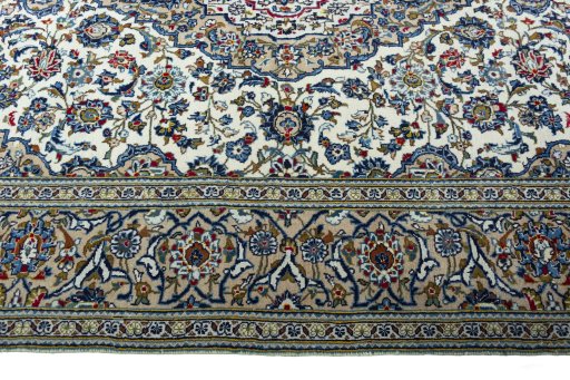 Corner detail of 2000s Kashan rug showing border pattern and Wool pile