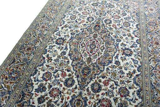 Backside of handmade 2000s Kashan rug showing knot structure and weave density
