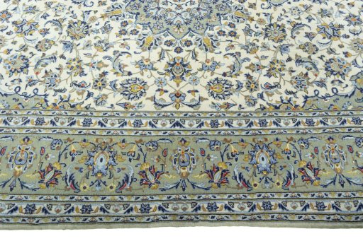 Corner detail of 2000s Kashan rug showing border pattern and Cork pile