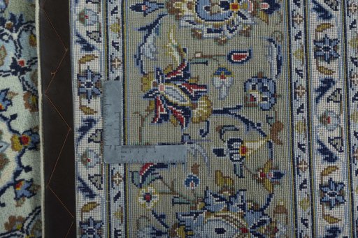 Backside of handmade 2000s Kashan rug showing knot structure and weave density