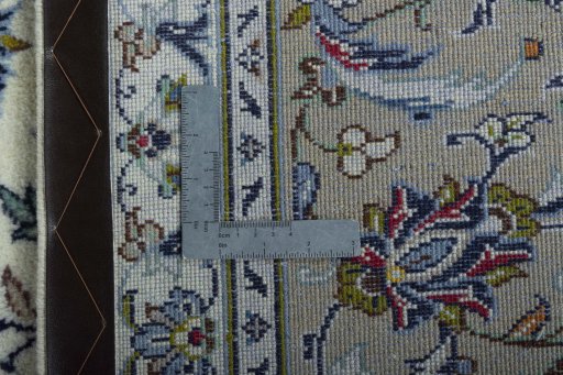 Backside of handmade New Kashan rug showing knot structure and weave density