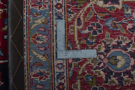 Backside of handmade 2000s Kashan rug showing knot structure and weave density