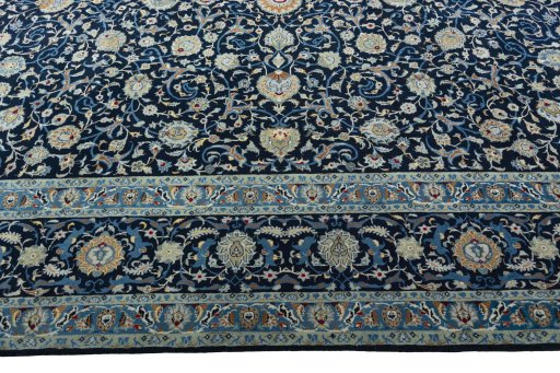 Corner detail of 2000s Kashan rug showing border pattern and Wool pile