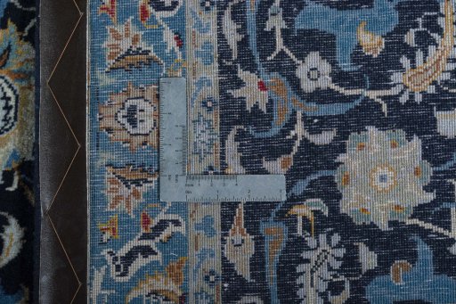 Backside of handmade 2000s Kashan rug showing knot structure and weave density