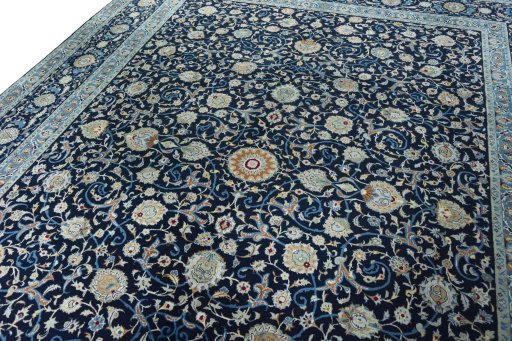 Backside of handmade 2000s Kashan rug showing knot structure and weave density