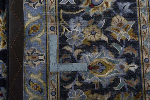 Backside of handmade 1970s Kashan rug showing knot structure and weave density