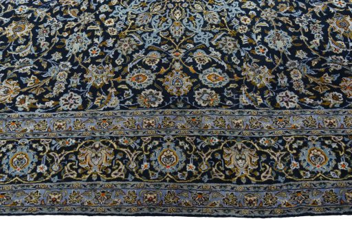 Corner detail of 2000s Kashan rug showing border pattern and Wool pile