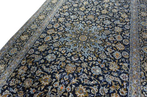 Backside of handmade 2000s Kashan rug showing knot structure and weave density