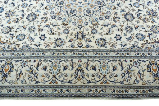 Corner detail of 2000s Kashan rug showing border pattern and Wool pile
