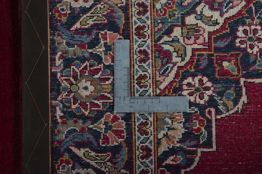 Backside of handmade 1930s Kashan rug showing knot structure and weave density