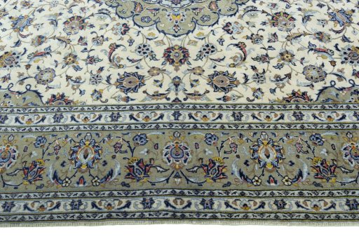 Corner detail of 2000s Kashan rug showing border pattern and Cork pile