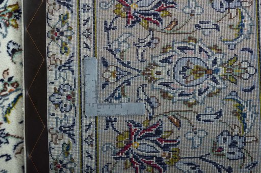 Backside of handmade 2000s Kashan rug showing knot structure and weave density