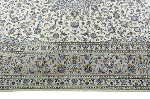 Corner detail of 2000s Kashan rug showing border pattern and Wool pile