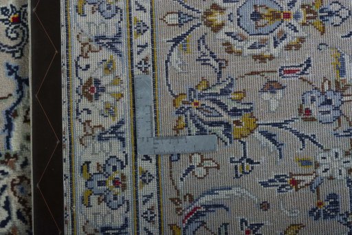 Backside of handmade 2000s Kashan rug showing knot structure and weave density