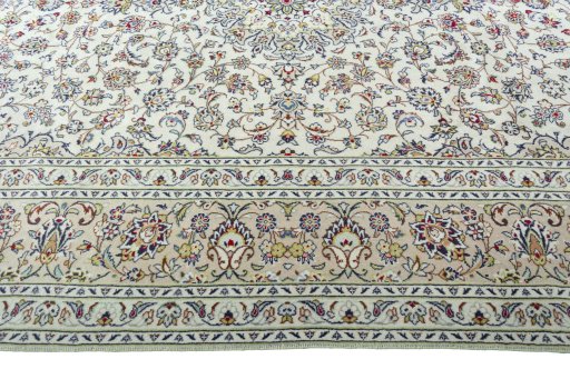 Corner detail of 2000s Kashan rug showing border pattern and Wool pile