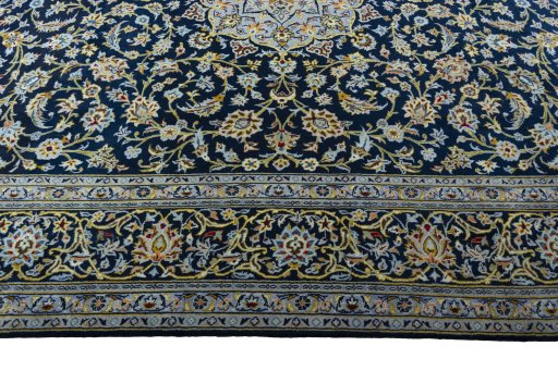 Corner detail of 2000s Kashan rug showing border pattern and Wool pile