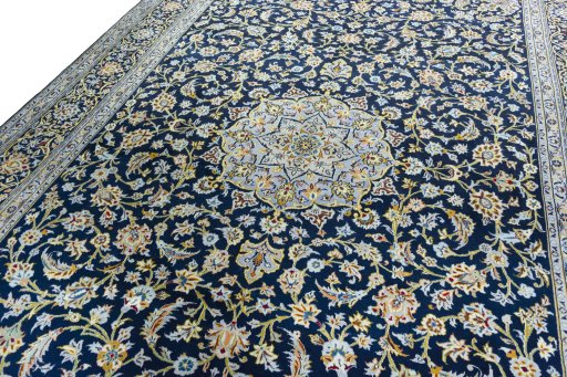 Backside of handmade 2000s Kashan rug showing knot structure and weave density