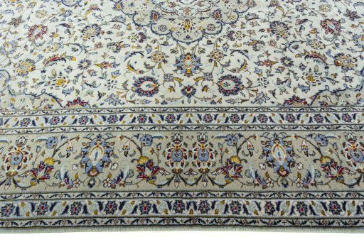 Corner detail of 2000s Kashan rug showing border pattern and Wool pile