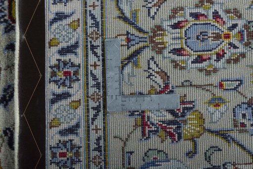 Backside of handmade 2000s Kashan rug showing knot structure and weave density