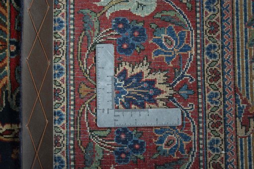 Backside of handmade 1930s Kashan rug showing knot structure and weave density