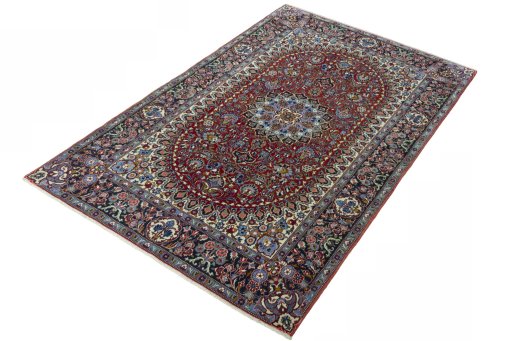 Corner detail of 2000s Kashan rug showing border pattern and Cork pile