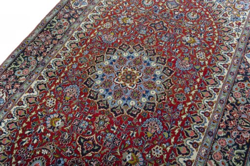 Backside of handmade 2000s Kashan rug showing knot structure and weave density