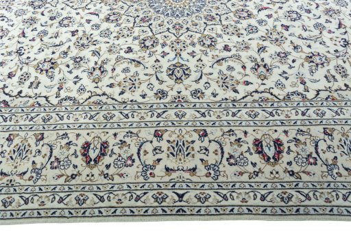 Corner detail of 2000s Kashan rug showing border pattern and Wool pile