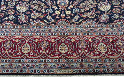 Corner detail of 2000s Kashan rug showing border pattern and Wool pile
