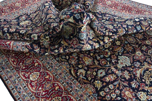 Backside of handmade 2000s Kashan rug showing knot structure and weave density
