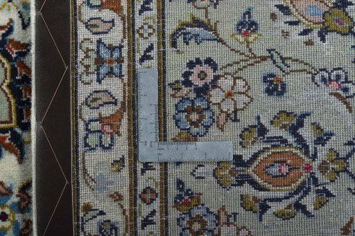 Backside of handmade 2000s Kashan rug showing knot structure and weave density