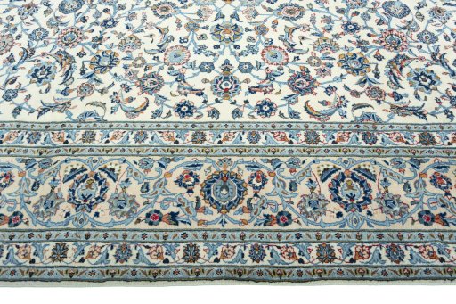 Corner detail of 2000s Kashan rug showing border pattern and Wool pile