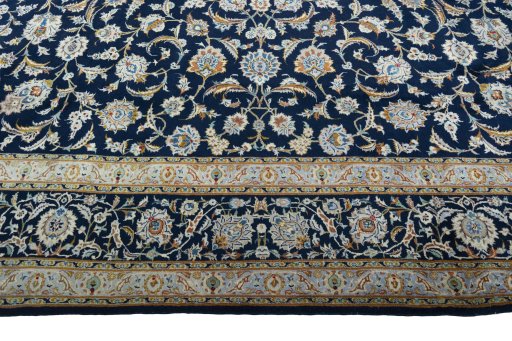Corner detail of 2000s Kashan rug showing border pattern and Wool pile