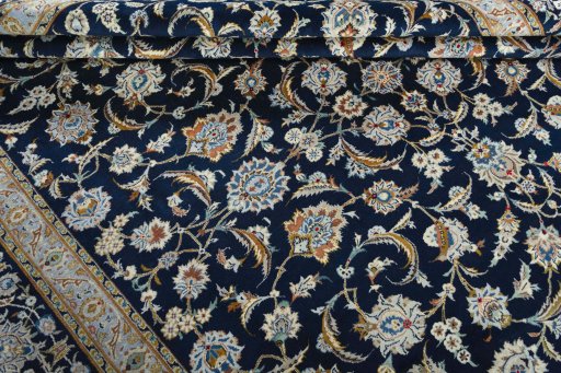 Close-up detail of 2000s Kashan rug from Iran / Persia showing Wool weave